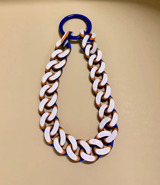 The matching New York Knicks colors Hype Chain wristlet connected with a blue o-ring carabiner.