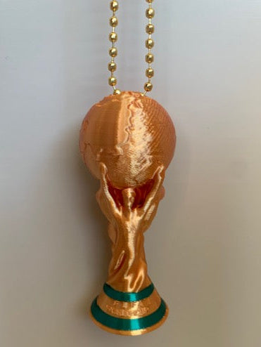 Hanging view of a 3D printed FIFA World Cup Trophy keychain in shiny gold with green base accents and gold bead chain hardware.