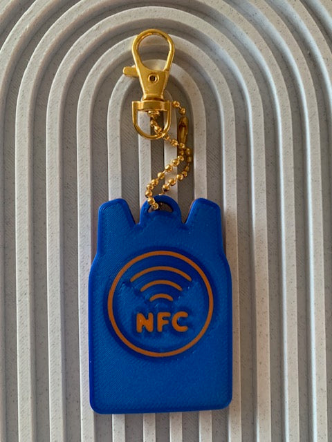 Back of blue and orange SAFE Tag keychain with orange NFC symbol