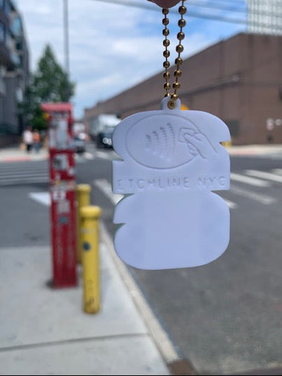 Back of FIFA World Cup can tab opener keychain with NFC symbol and Etchline NYC maker mark on the streets of Brooklyn