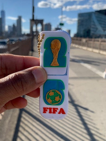 FIFA World Cup inspired phone holder fidget keychain held on the Brooklyn Bridge