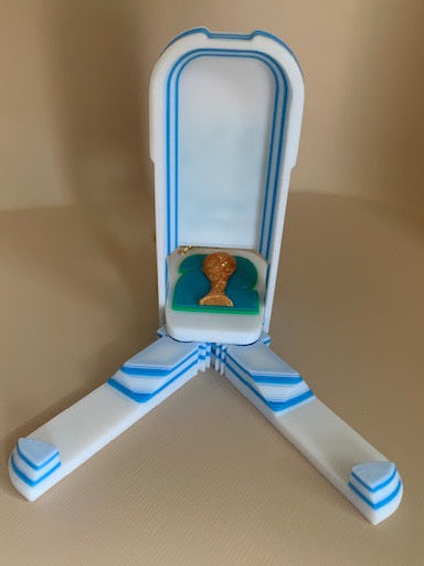 FIFA World Cup phone holder fidget keychain opened into a triangular phone stand with trophy detail and blue-and-white layered base.
