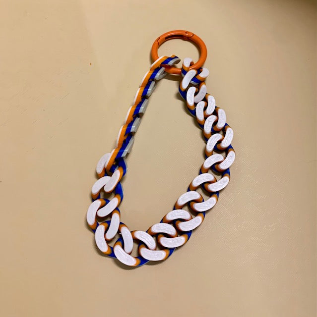 The matching New York Knicks colors Hype Chain wristlet connected with an orange o-ring carabiner. 