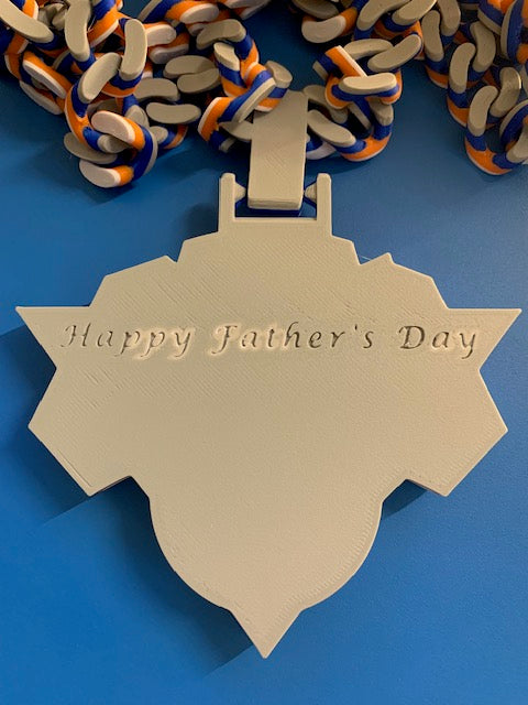 The back of the Knicks Hype Chain personalized with the phrase "Happy Father's Day" on it, like it's embossed.