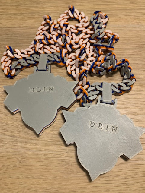 The back of the Knicks Hype Chain personalized with the name "Blin" and "Drin" on it, like it's embossed.