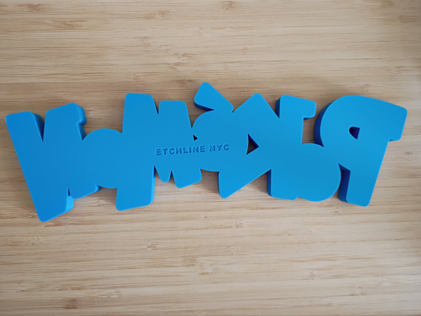 Back of Pokémon 3D printed desktop and wall sign showing Etchline NYC maker mark