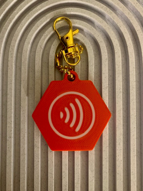 Back of red medical NFC SAFE Keychain with white tap symbol