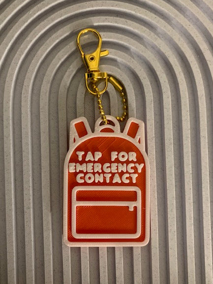 Red and white backpack SAFE Tag keychain that says Tap for Emergency Contact